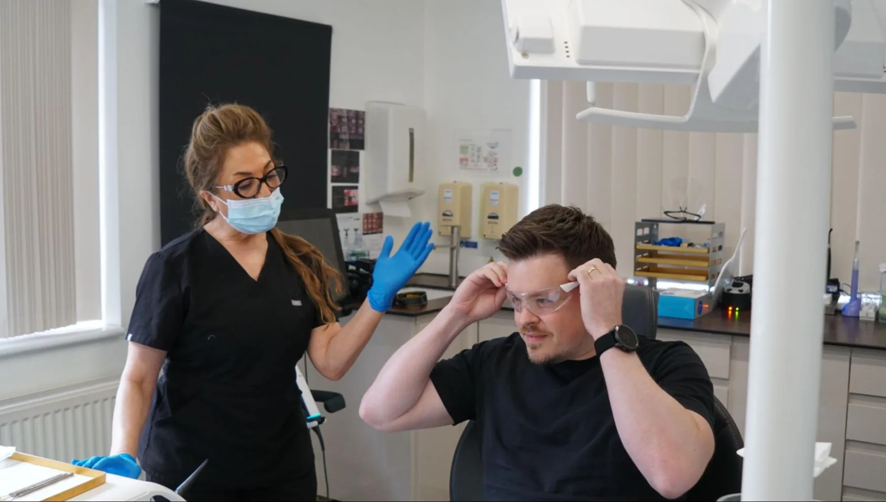 Taverham dentist examining a patient's oral health during a consultation